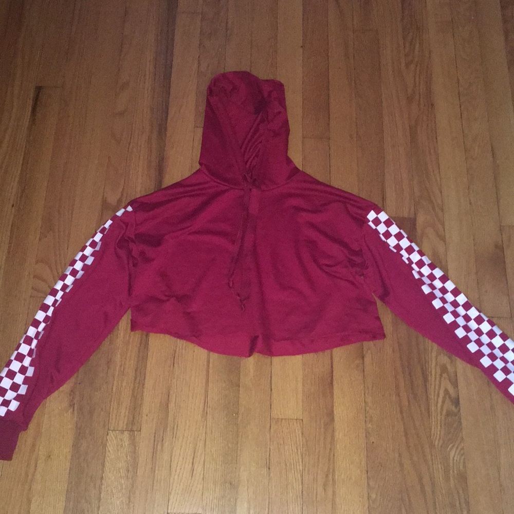 red sweater with checkered sleeves.